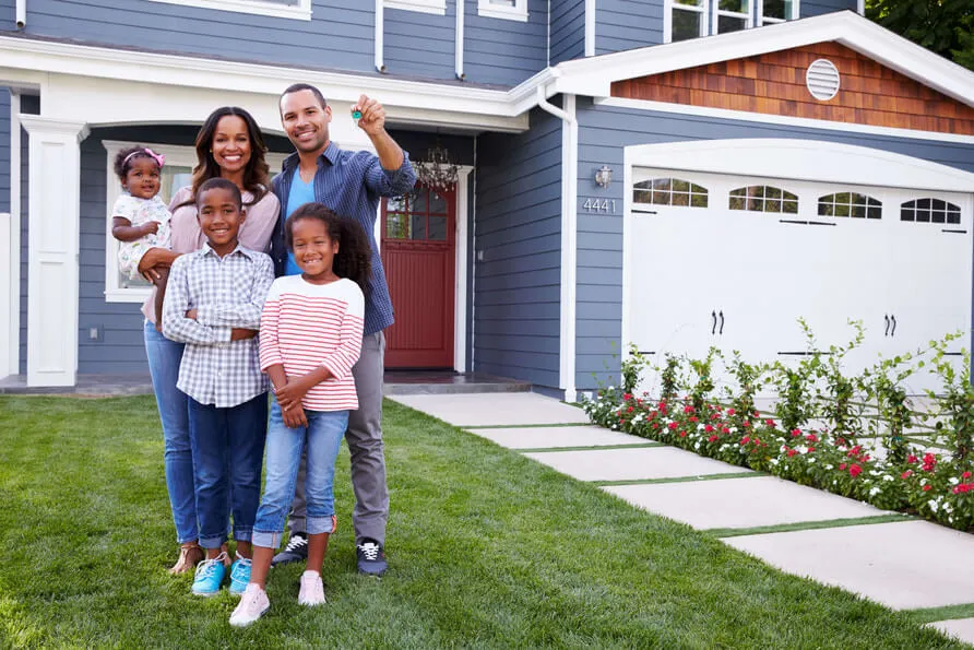 Picture of family holding hands outside home